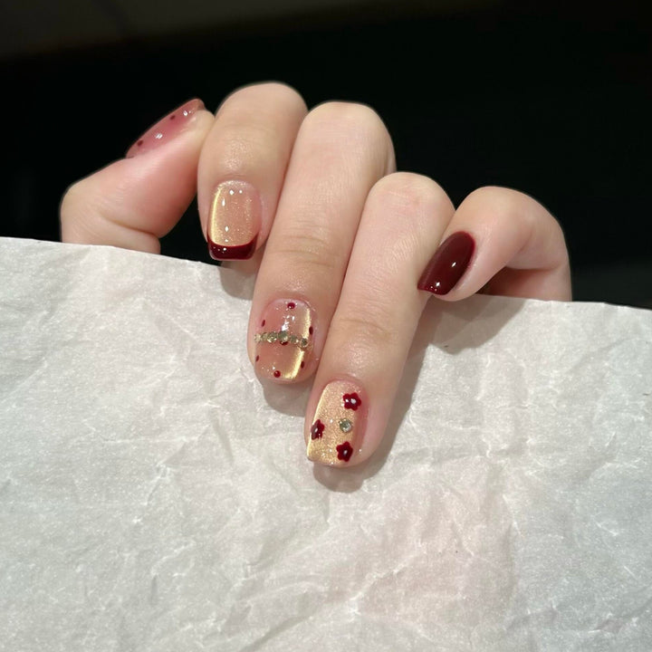 Artificial nails in luxurious glamour design with floral and glittering accents Stornfield