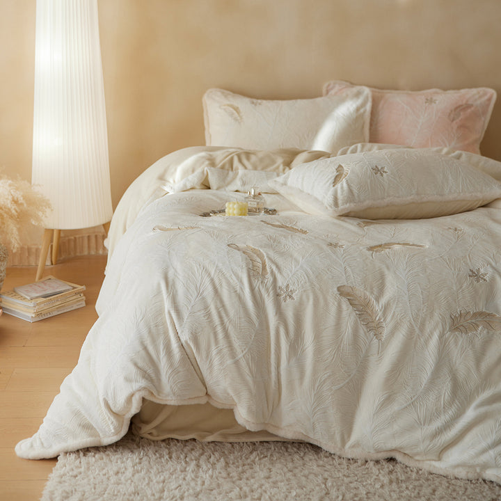 Velvet reversible bedding set with embossed feather pattern and plush border