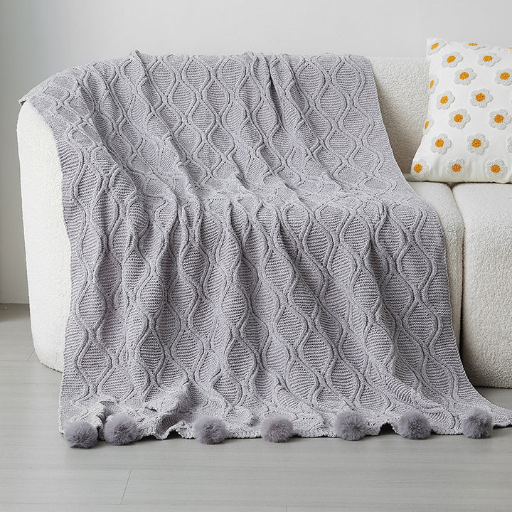 Ladies knit blanket with decorative pom poms Stornfield