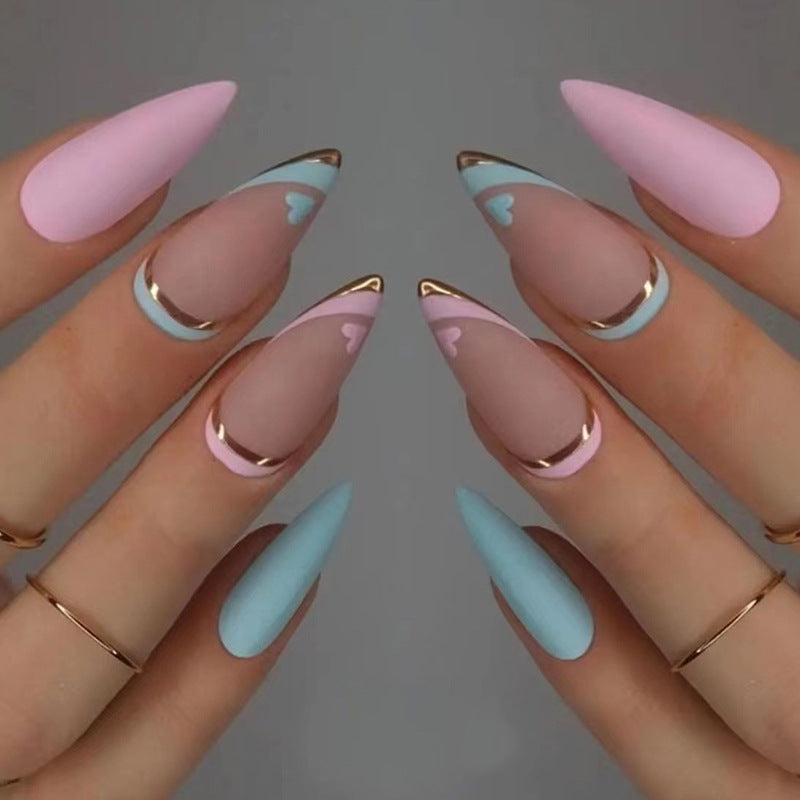 Artistic stiletto nails with gold accents and heart design Stornfield