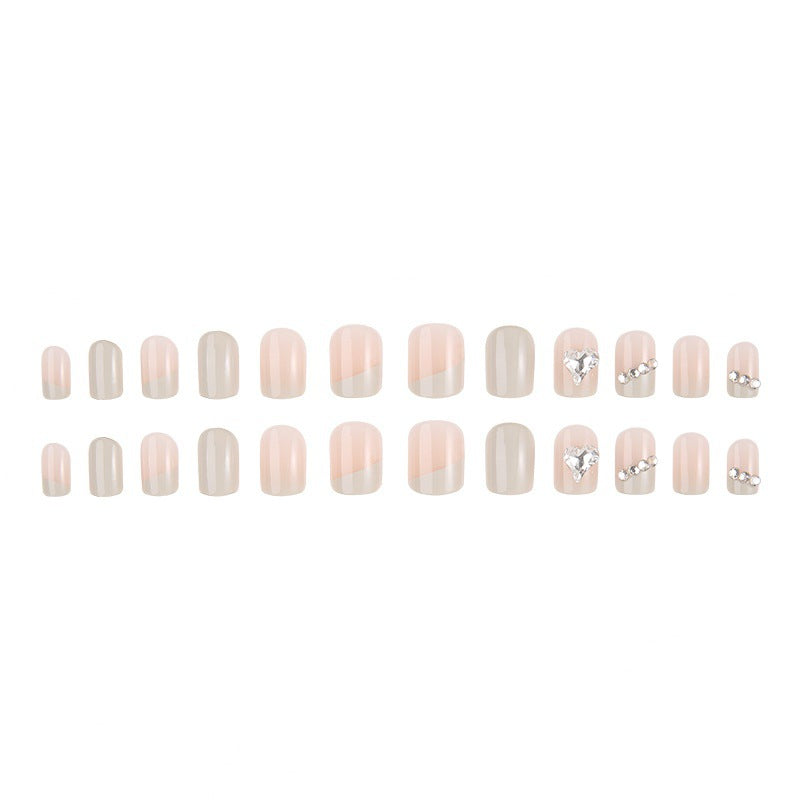 Glamorous artificial nails with heart and rhinestone decorations Stornfield