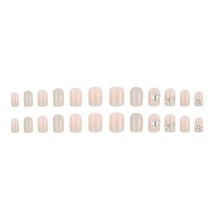 Glamorous artificial nails with heart and rhinestone decorations Stornfield