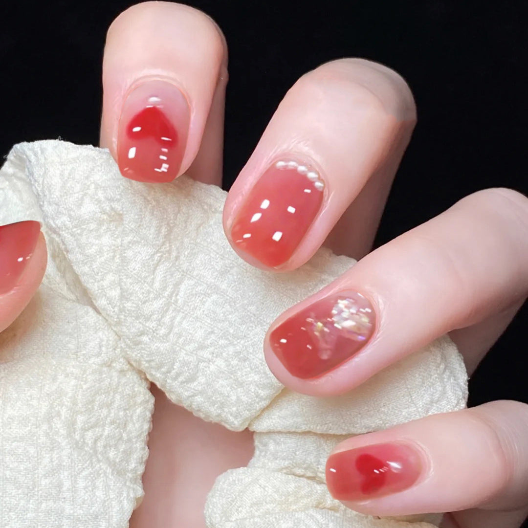 Artful nail art with radiant shine and heart motifs Stornfield