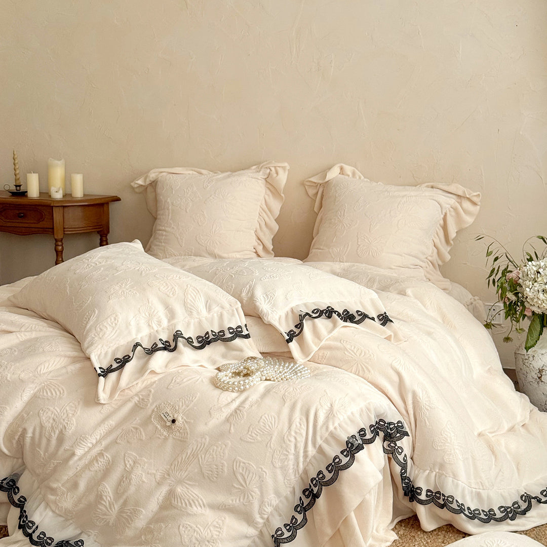 Romantic bedding set with lace trim, ruffle, and quilted blanket