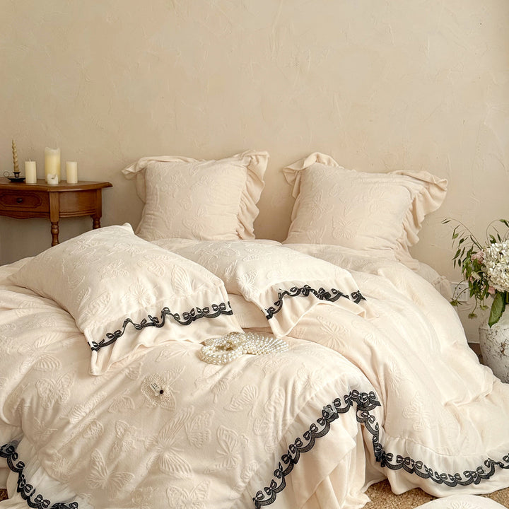 Romantic bedding set with lace trim, ruffle, and quilted blanket