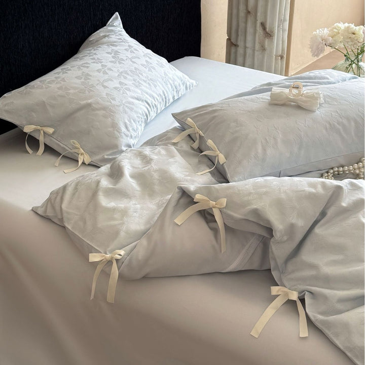 Luxurious cotton satin bed set with delicate ribbon ties and jacquard relief