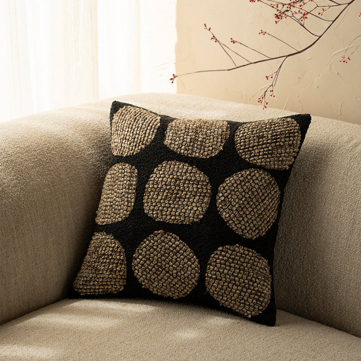 Decorative cushion cover made of textured bouclé weaving technique with raised round appliqués