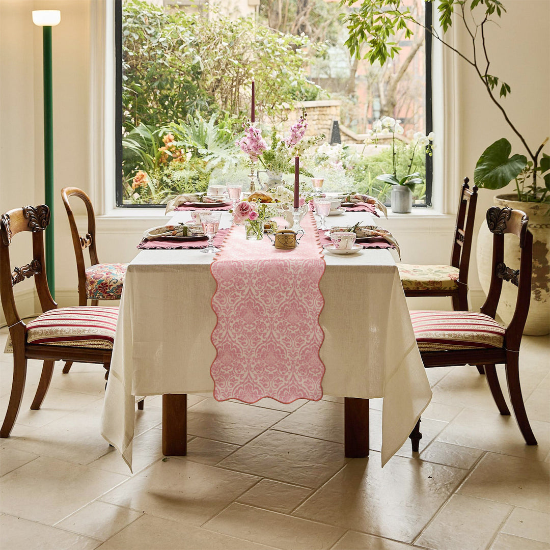 Elegant table runner with wavy hem and baroque damask pattern