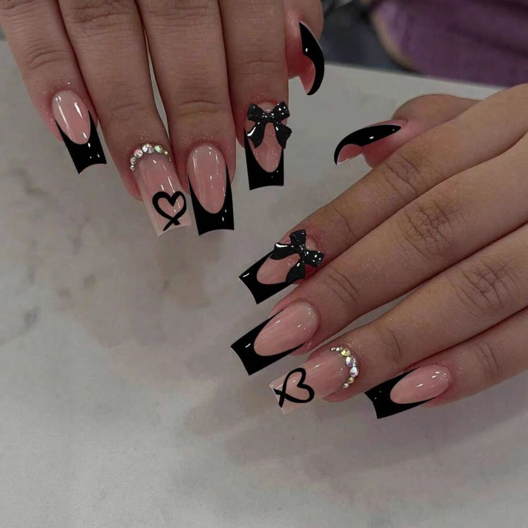 Acrylic nail set with elegant heart and bow design Stornfield