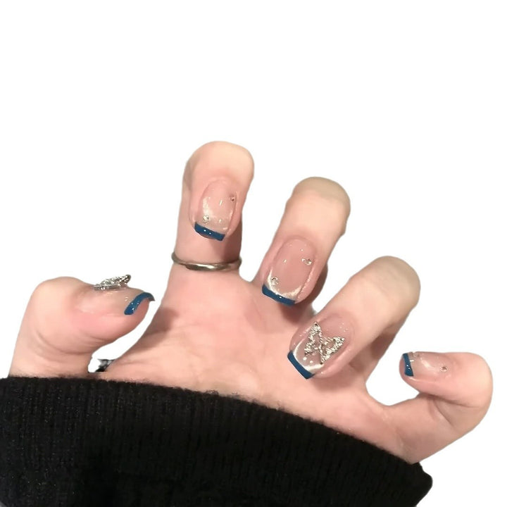Artificial nails with trendy French tips and decorative glitter accents Stornfield