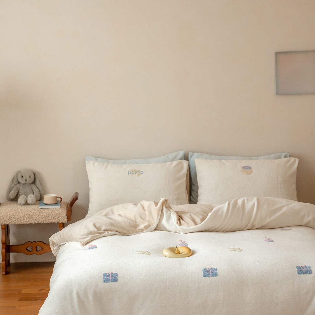 Bedding set with embroidered motif details, pompom trim and soft woven cotton finish