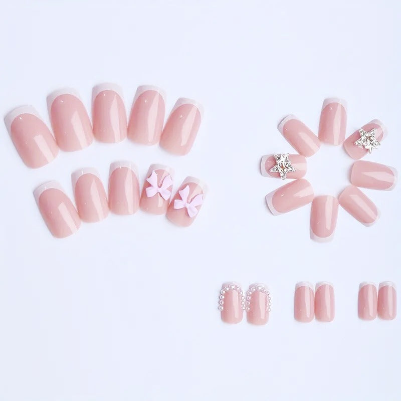 Artificial nail tips with glamorous bow and rhinestone design Stornfield