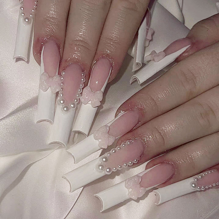 Artistic and elegant acrylic nails with pearl and flower decor Stornfield
