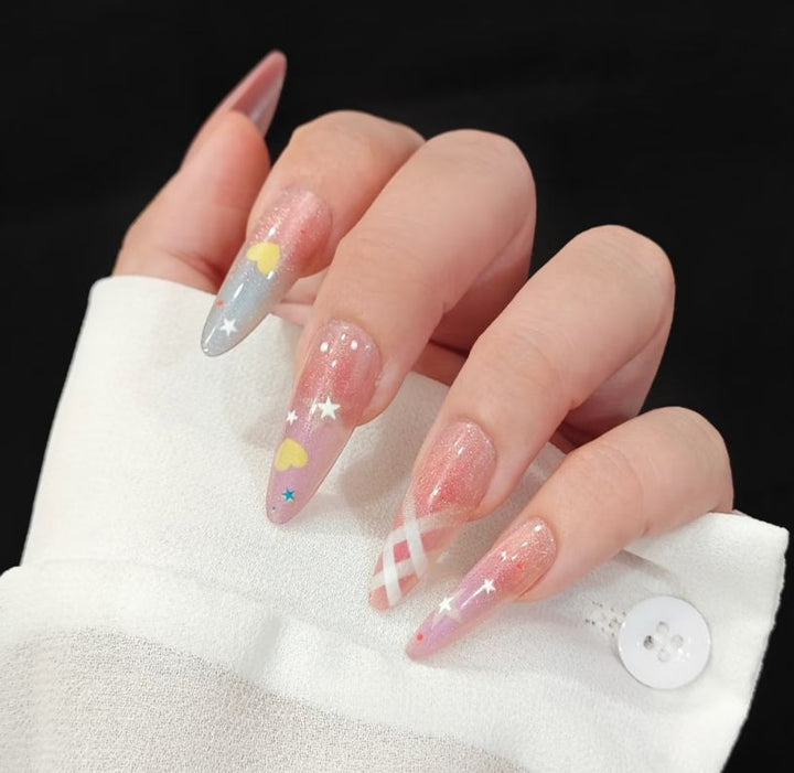 Playful artificial nails with glitter and colorful patterns Stornfield