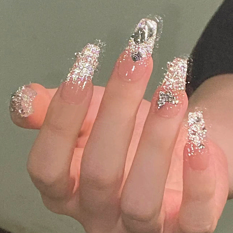 Glamorous artificial nails with sparkling rhinestones and elegant designs Stornfield
