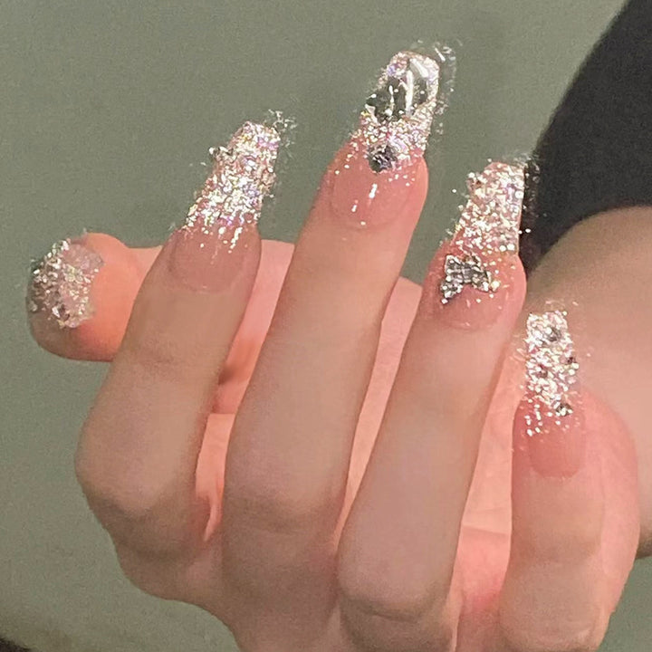Glamorous artificial nails with sparkling rhinestones and elegant designs Stornfield