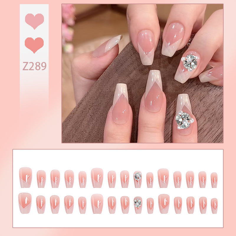 Artificial nail set with filigree tip designs and glamorous rhinestone accents Stornfield