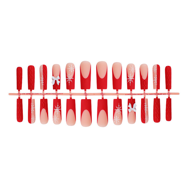 Artificial nail set with festive snowflake and bow motifs Stornfield