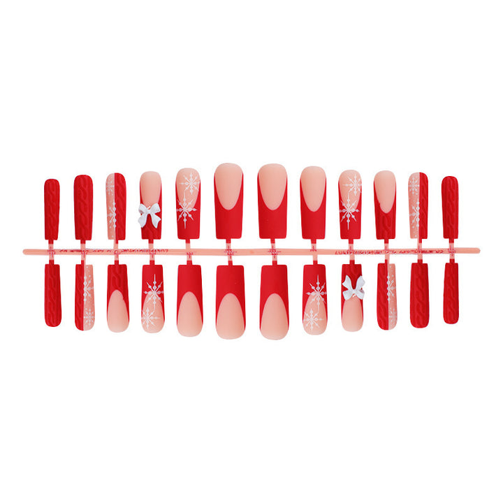 Artificial nail set with festive snowflake and bow motifs Stornfield