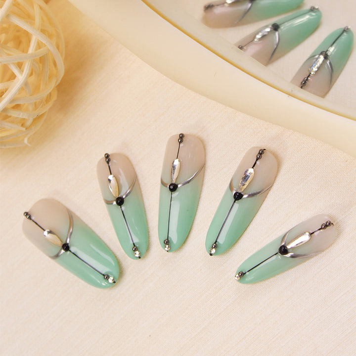 Acrylic nail set with elegant ombre effect and glamorous embellishments Stornfield