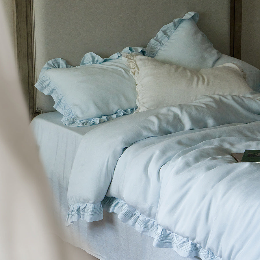 Cotton muslin duvet cover and pillowcase set with ruffle trim and finely striped piping