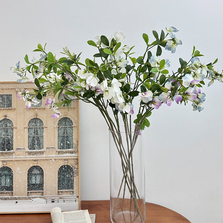 Artificial flower branch with vibrant pink flowers