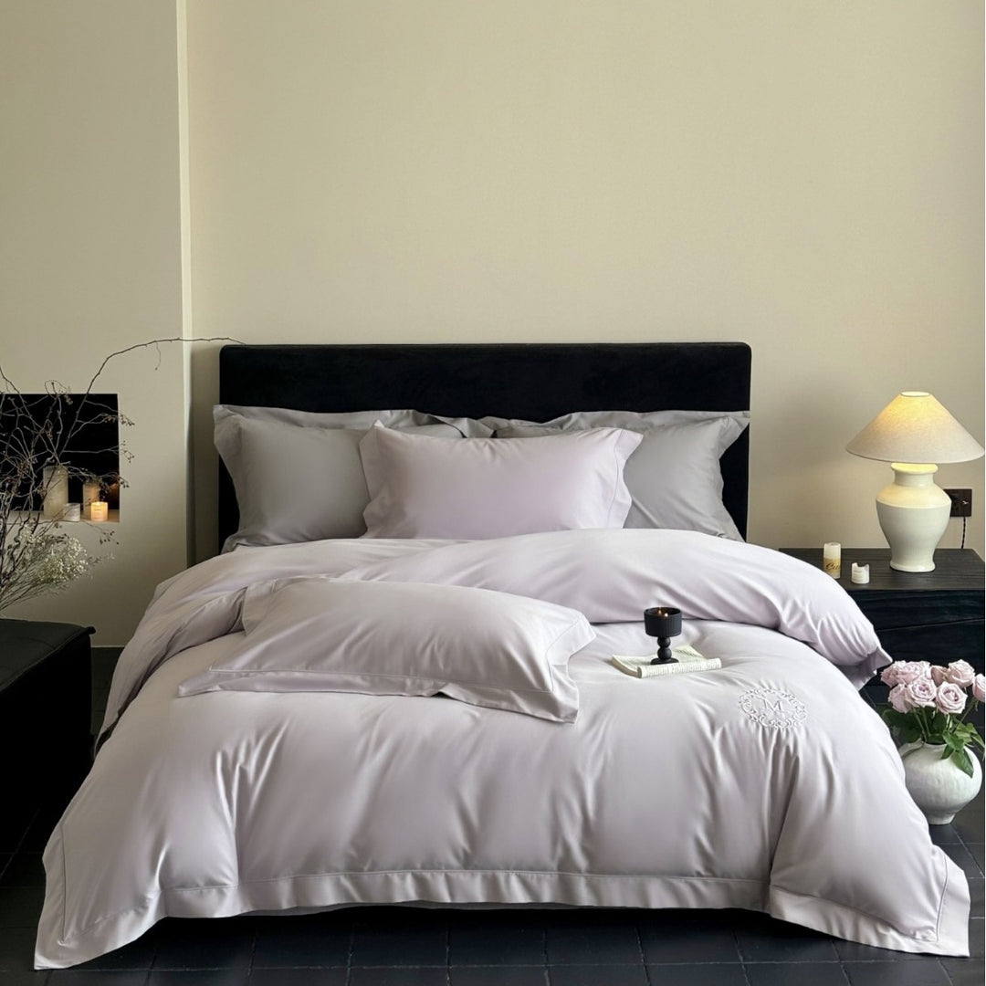 Luxurious cotton satin bedding set with monogram embroidery and fine piping