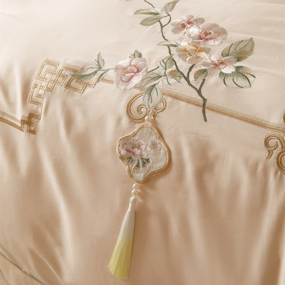 Luxurious cotton satin bedding set with fine embroidery, floral motifs, and decorative pillows