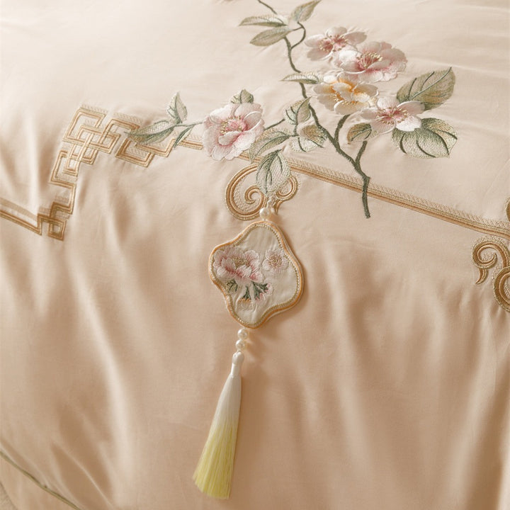Luxurious cotton satin bedding set with fine embroidery, floral motifs, and decorative pillows