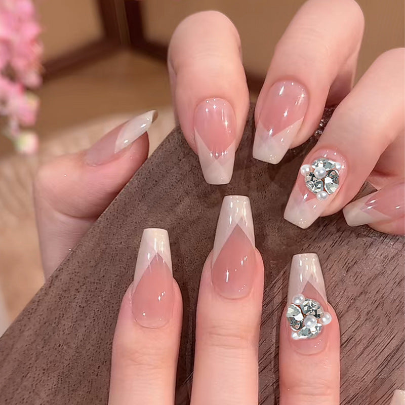 Artificial nail set with filigree tip designs and glamorous rhinestone accents Stornfield