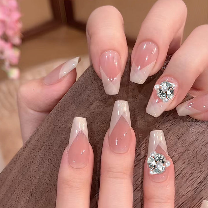 Artificial nail set with filigree tip designs and glamorous rhinestone accents Stornfield