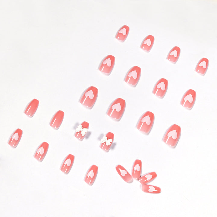 Artistic acrylic nails with heart and bow motifs Stornfield