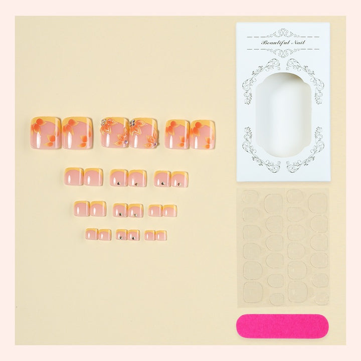 Artificial nail set with floral design and glitter accents Stornfield