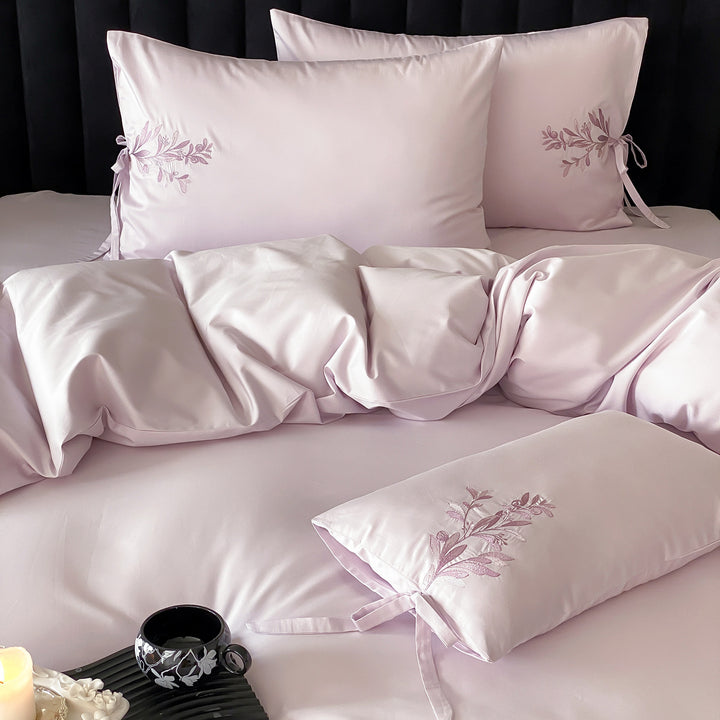 Premium cotton satin bedding set with botanical embroidery and decorative cushion ties
