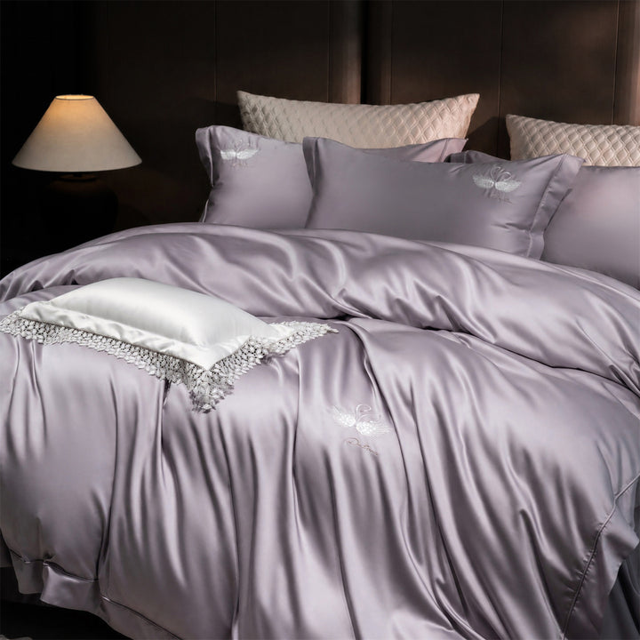 Luxurious satin bedding set with embroidered swan motif and lace pillow