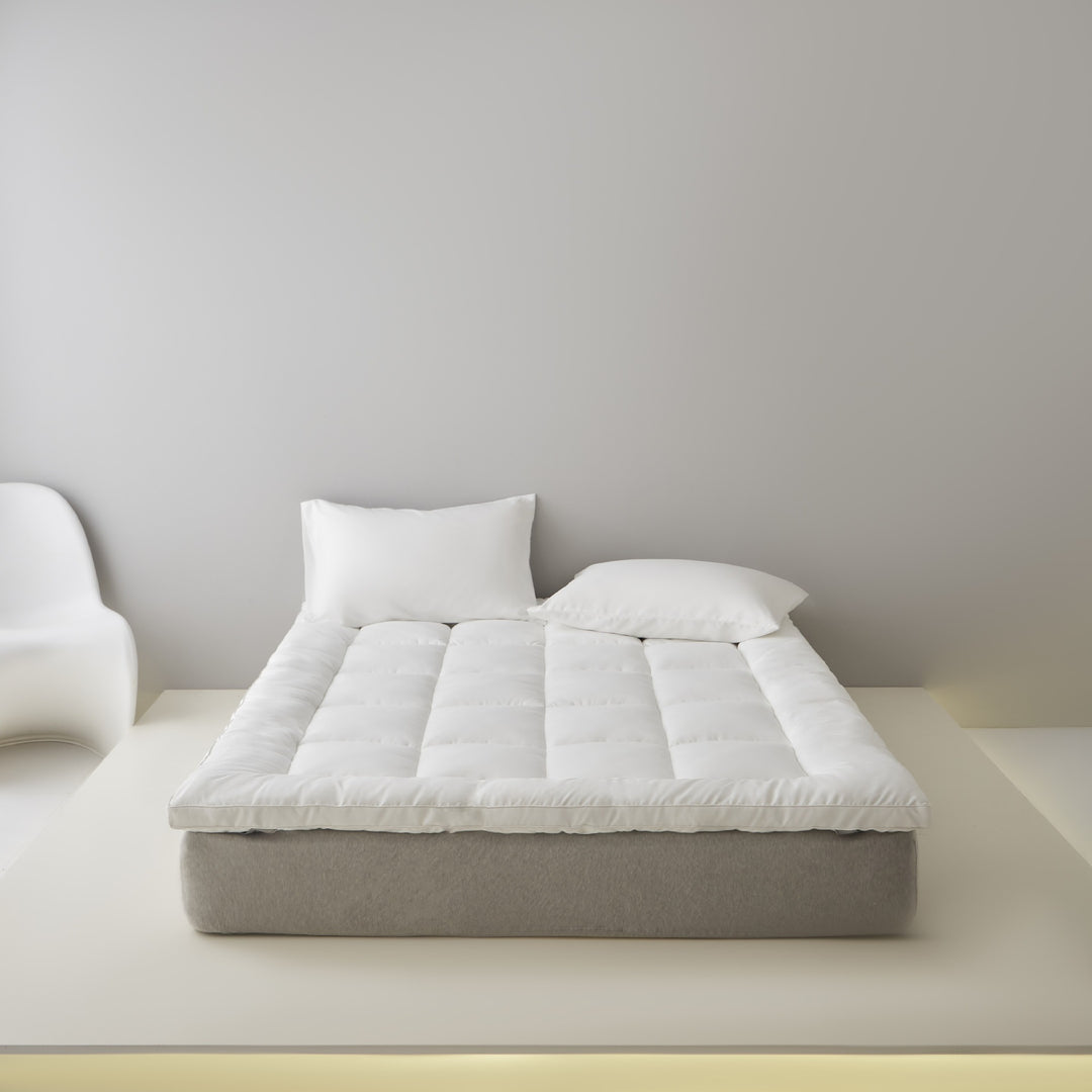 Extra soft quilted mattress topper with border piping and non-slip underside