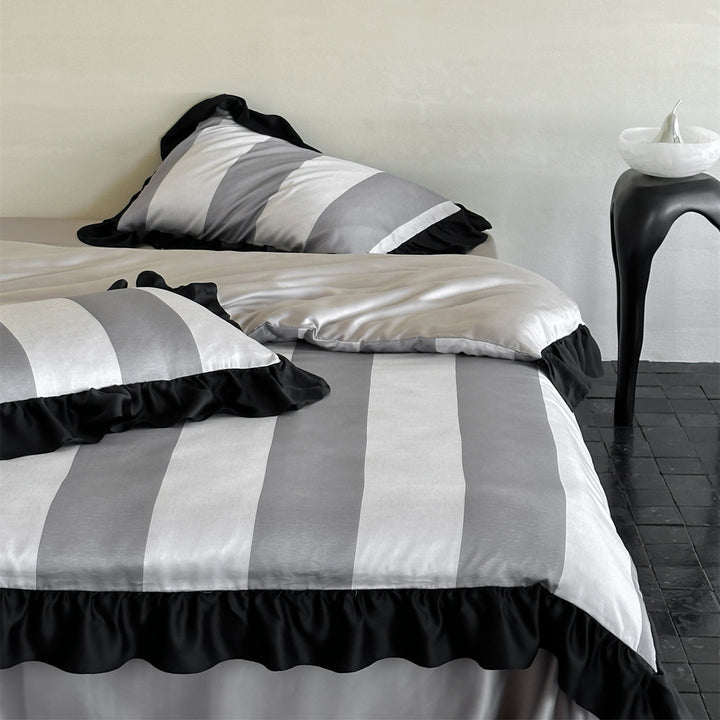 Luxurious satin bedding set with floral watercolor print, ruffled edges and reversible function