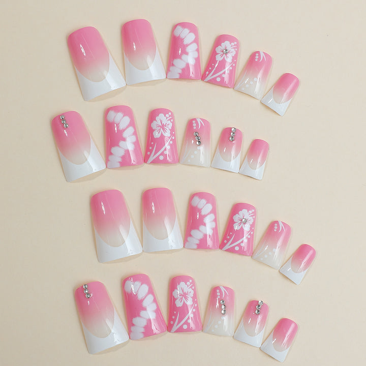 Acrylic nail set with elegant floral designs and glitter accents Stornfield