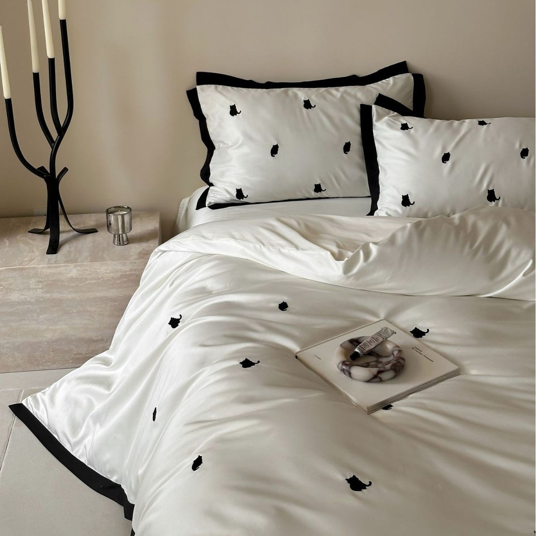 Elegant satin bed set with fine cherry embroidery and contrasting piping