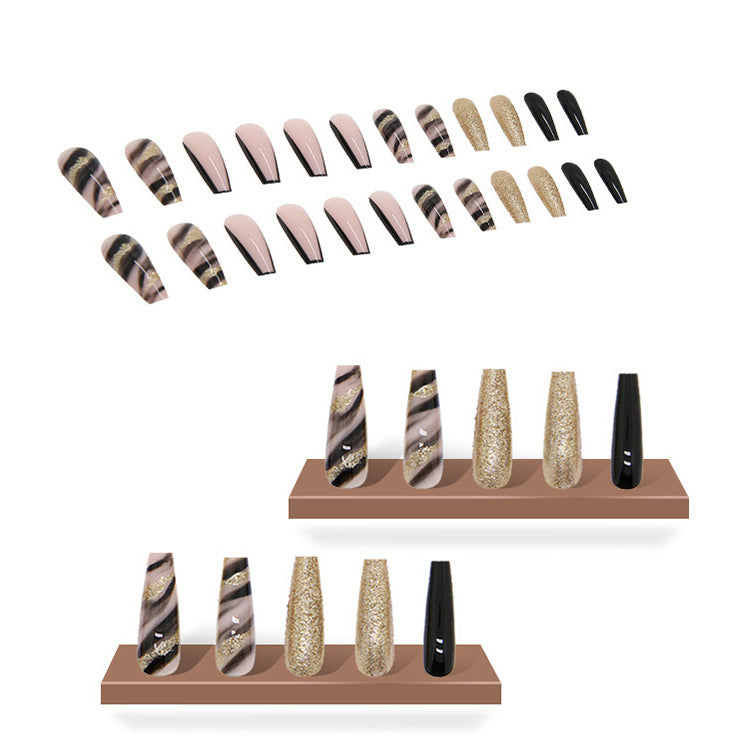 Acrylic nail set with luxurious golden accents and elegant designs Stornfield