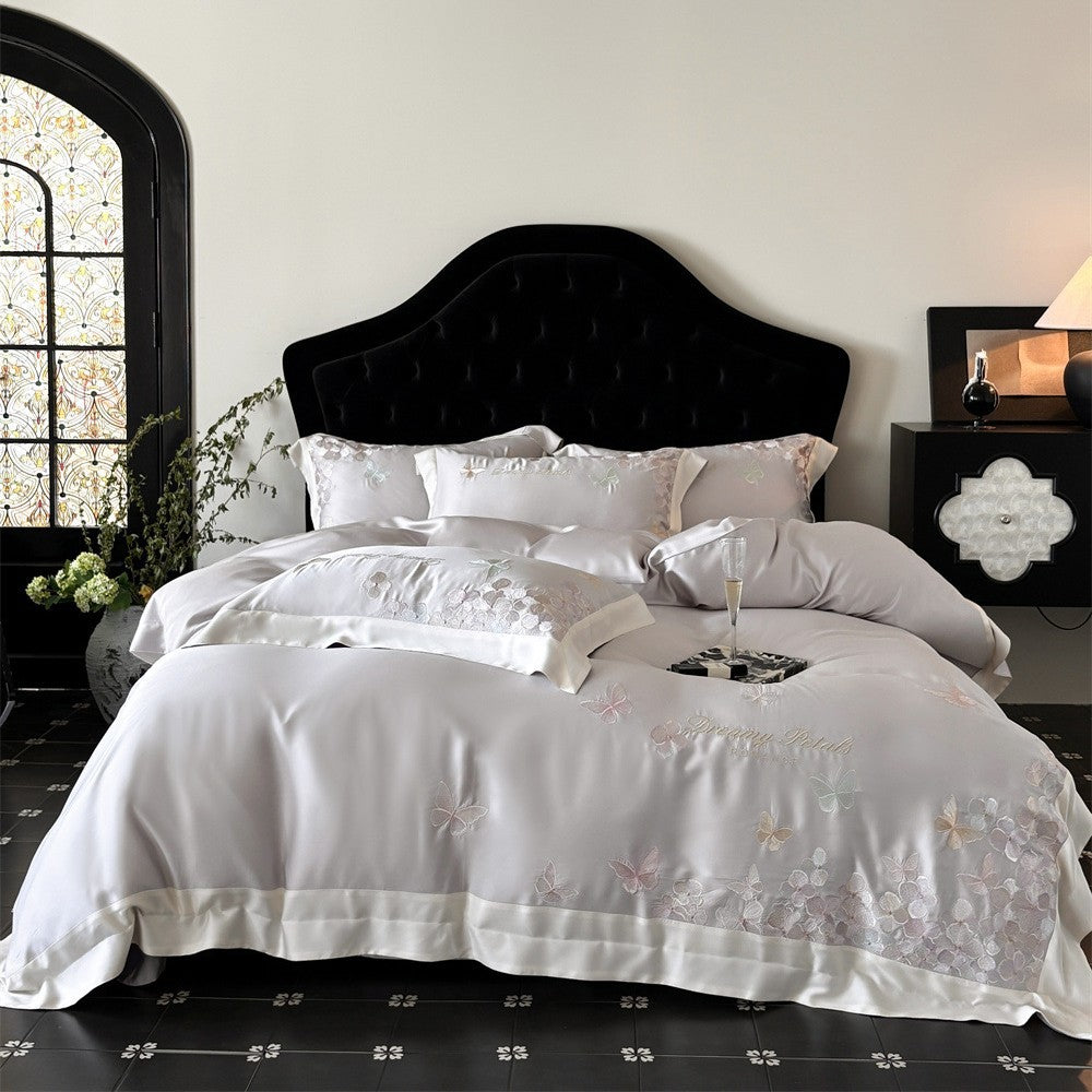Luxurious satin bedding set with embroidered butterfly and flower appliqués