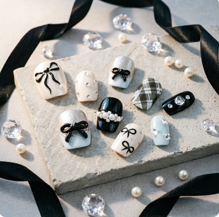 Artificial nails with elegant bows and rhinestones Stornfield