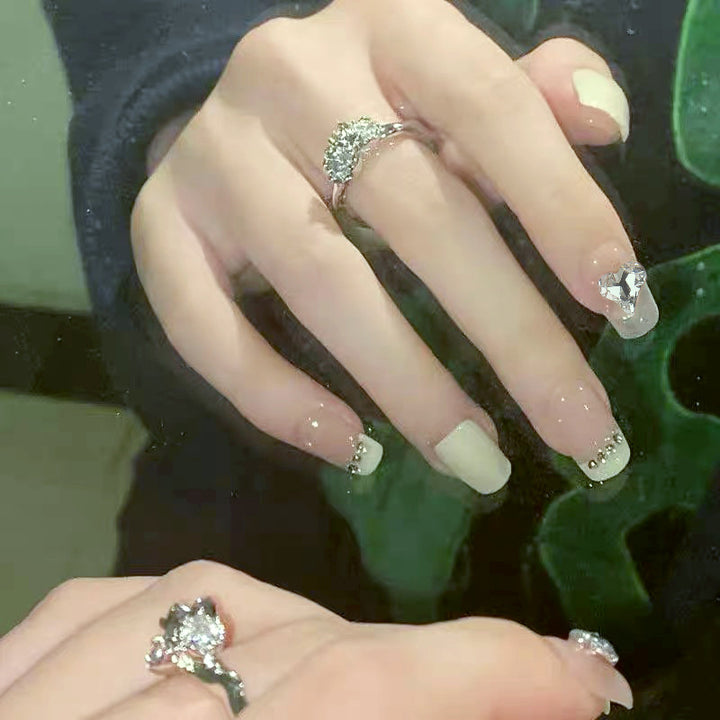 Glamorous artificial nails with heart and rhinestone decorations Stornfield