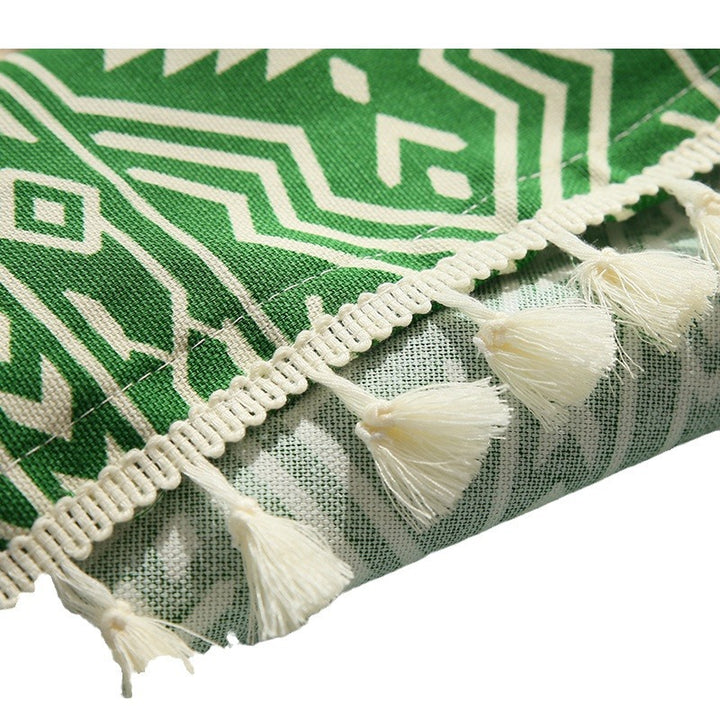 Woven cotton tablecloth with ethnic jacquard pattern and tassel trim