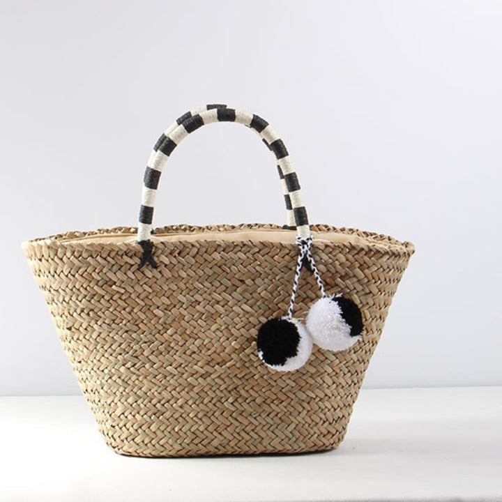 Braided beach bag with decorative pompons Stornfield