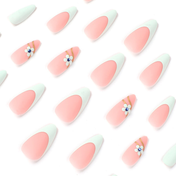 Artistic stiletto nails with floral accents and glitter embellishments Stornfield