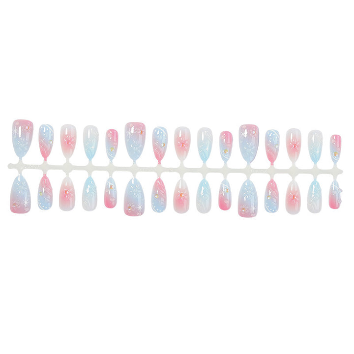 Acrylic nail set with elegant ombre design and floral decorations Stornfield