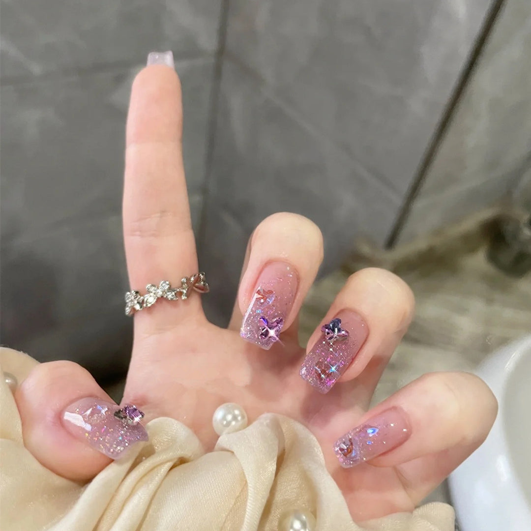 Glamorous artificial nails with glitter and floral accents Stornfield