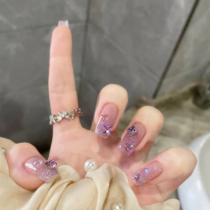 Glamorous artificial nails with glitter and floral accents Stornfield