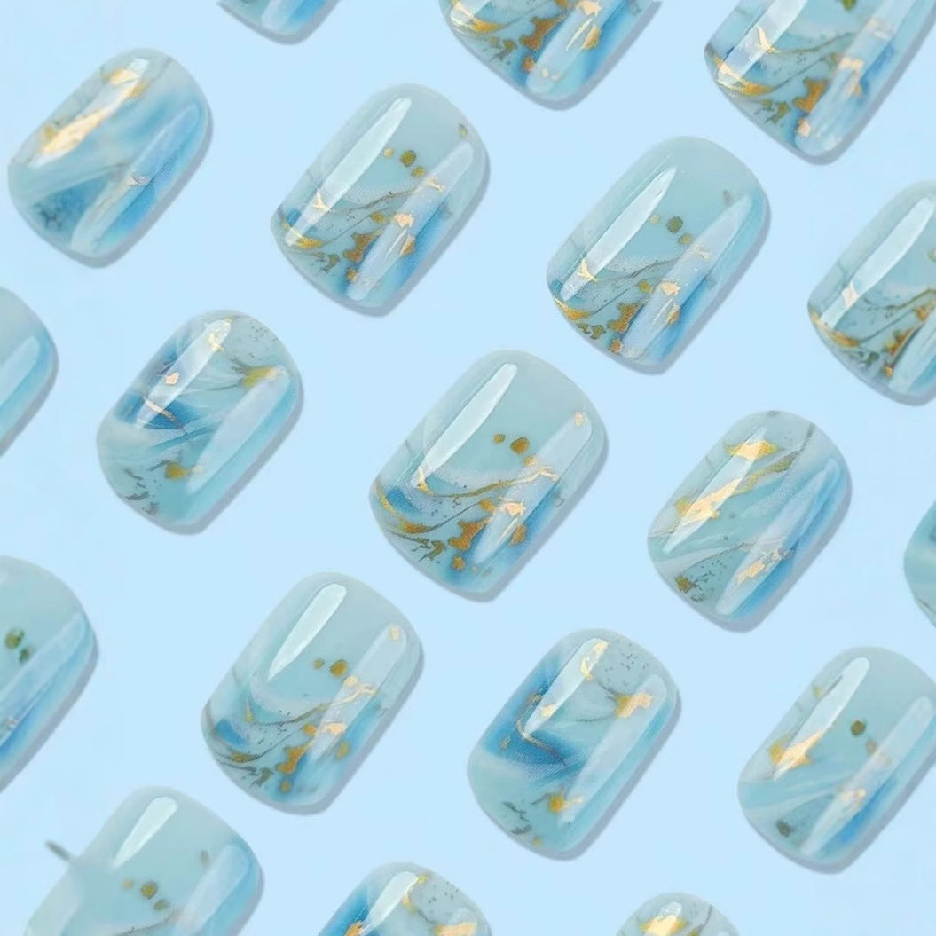 Acrylic nail set with luxurious marble design and gold accents Stornfield